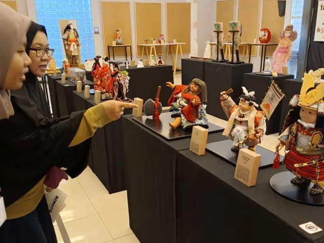 Seorang pengunjung sedang menanyakan ihwal Ningyo kepada penjaga pameran, Prima. (ist)